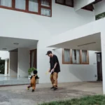 Father and son enjoying playful bonding time in front of a modern house.